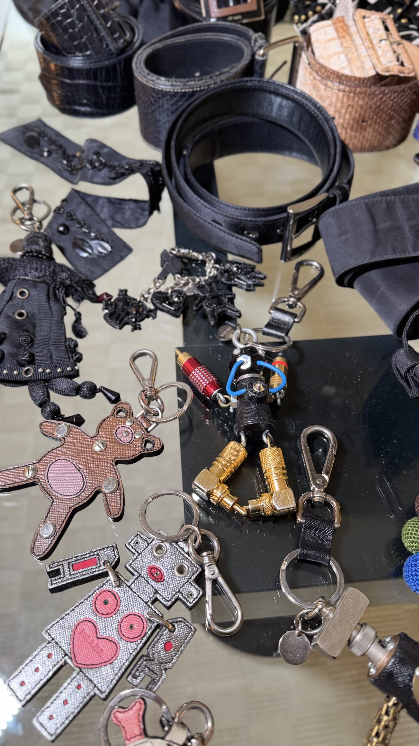 Prada keychains and belts
