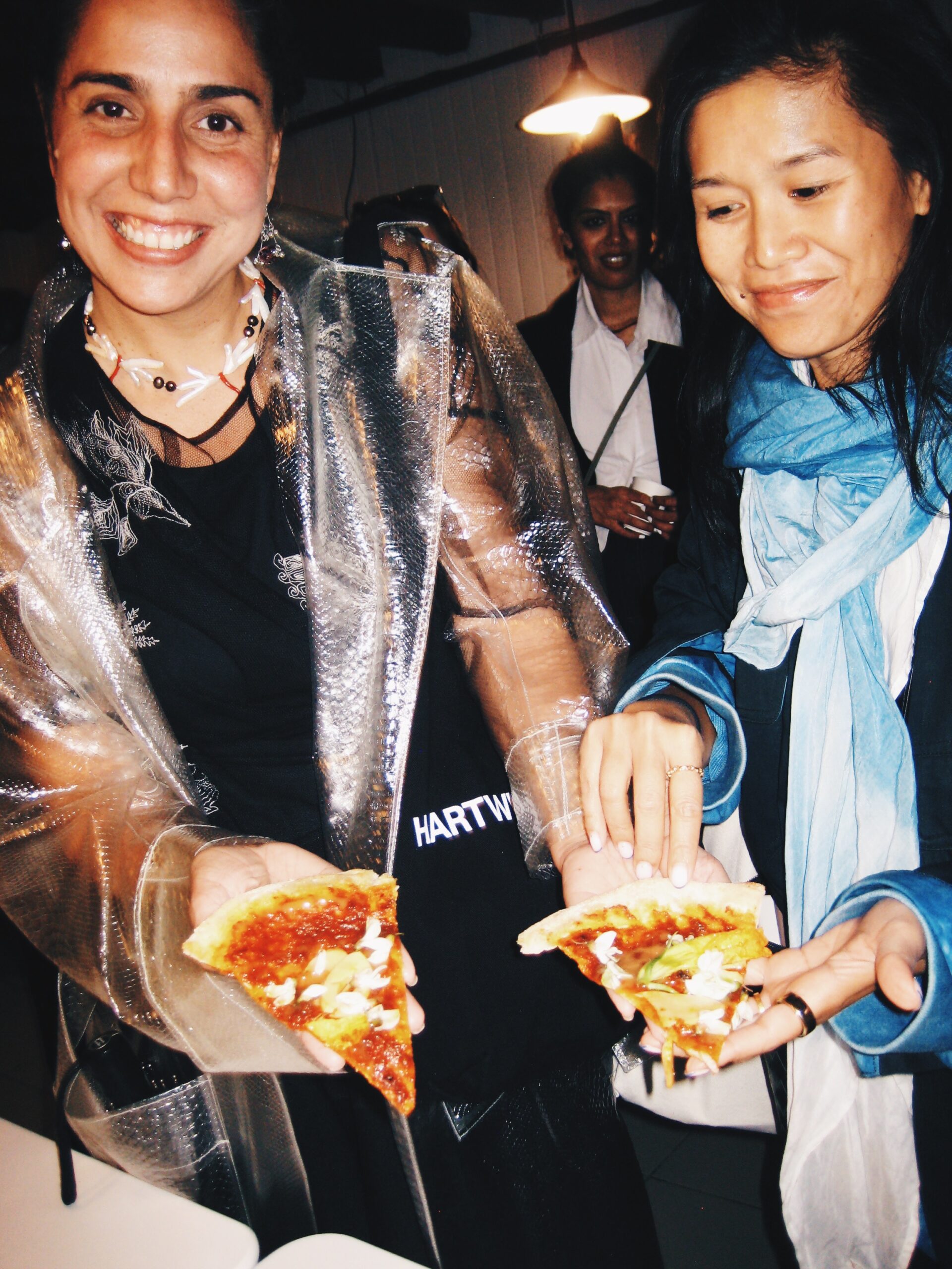 Diana Campbell and Chomwan Weeraworawit pose with their pizzas at the Pizzalo party in Venice