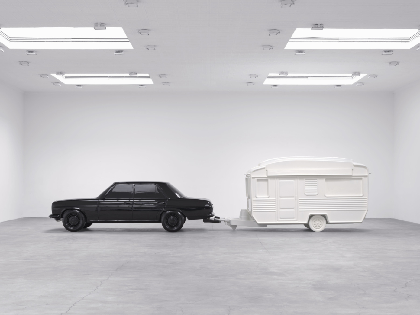 black car towing a white trailer
