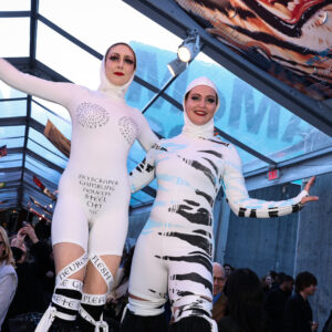 Tyler Morgan and Elizabeth Dee walk on stilts