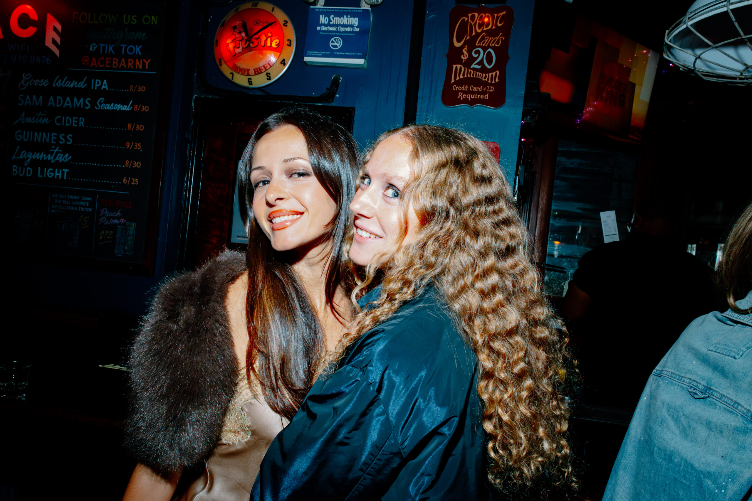 Two guests pose together inside the venue at The Holes event.