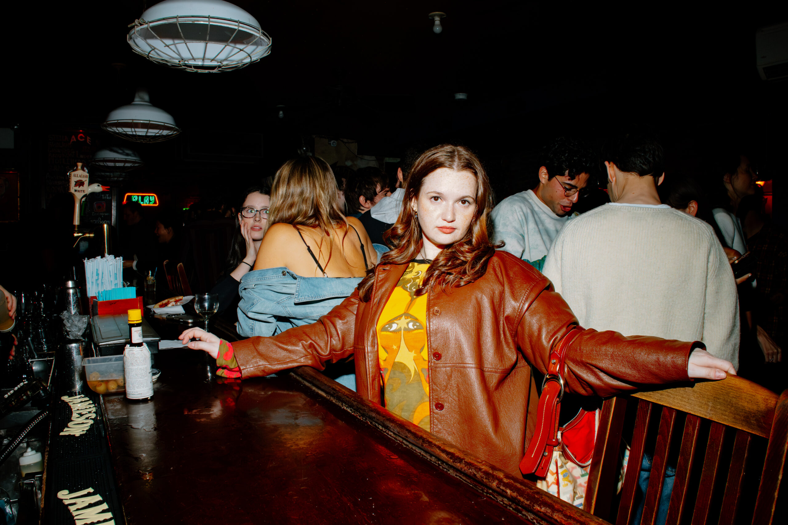 Keara Sullivan poses in an orange jacket inside the event venue.